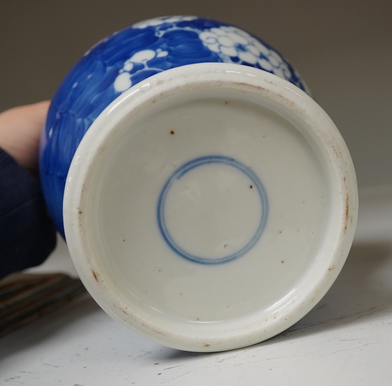 A 19th century Chinese blue and white 'prunus' vase, a Chinese green glazed jar, a Japanese vase and two dishes and two Canton famille rose plates (7). Condition - fair to good